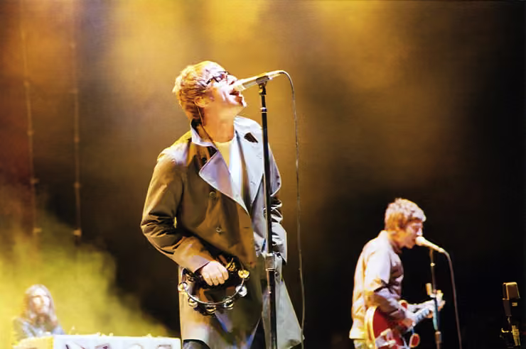 Liam and Noel Gallagher of Oasis performing together on stage